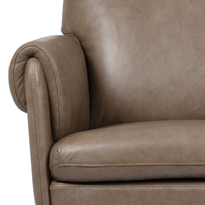 Close-up of a taupe brown leather armchair showing the rolled armrest, back cushion, and seat with visible leather grain texture.