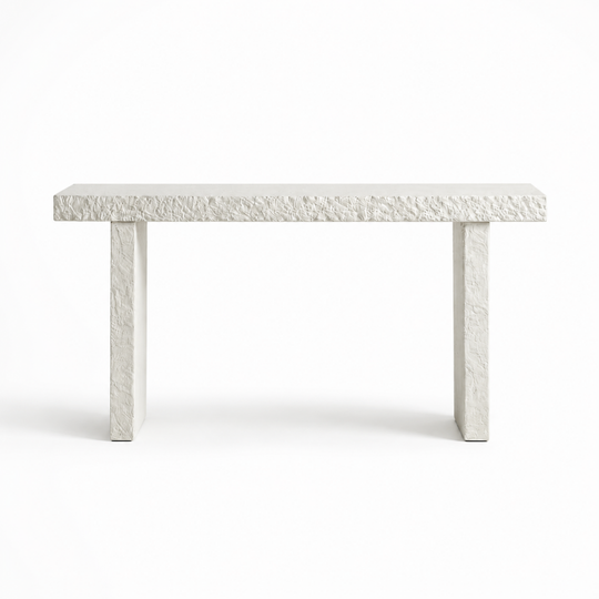A modern rectangular console table made of textured white stone or concrete, featuring a thick top and two thick blocky legs, shown against a plain white background.
