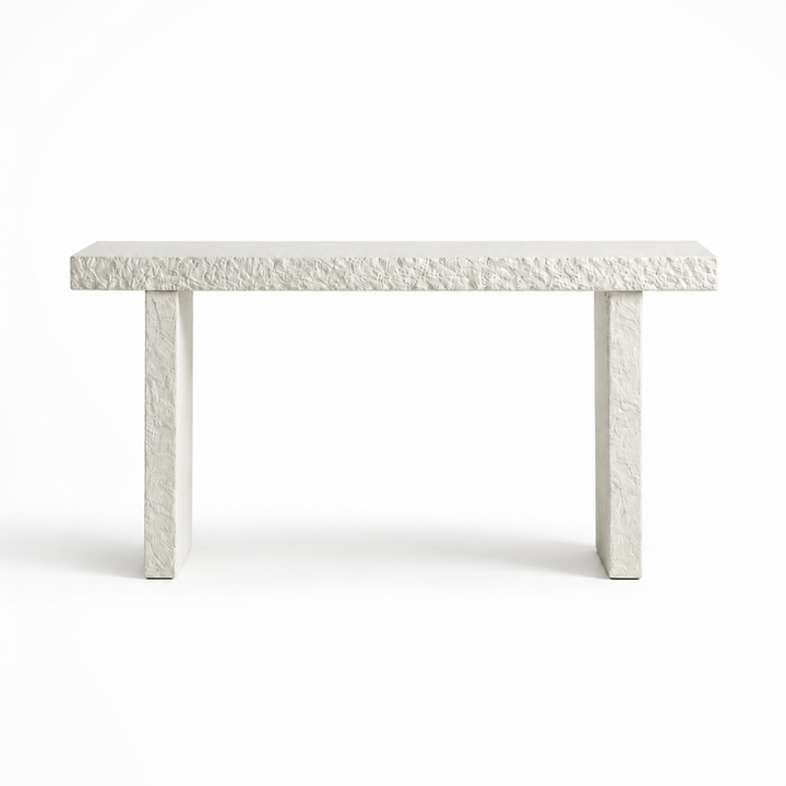 A modern rectangular console table made of textured white stone or concrete, featuring a thick top and two thick blocky legs, shown against a plain white background.