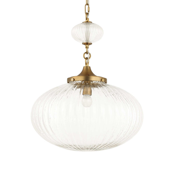 Decorative pendant light with glass shade and brass fixture on a white background
