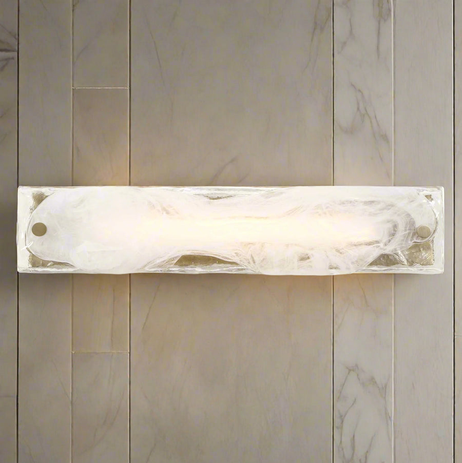 Wall-mounted light fixture with marble-like finish on a dark gray background