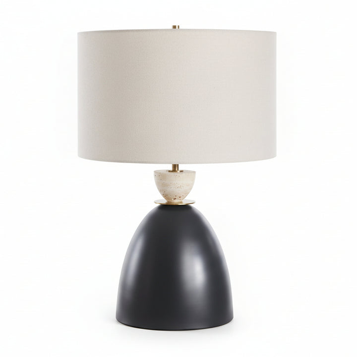Table lamp with a black base and beige shade on a white background