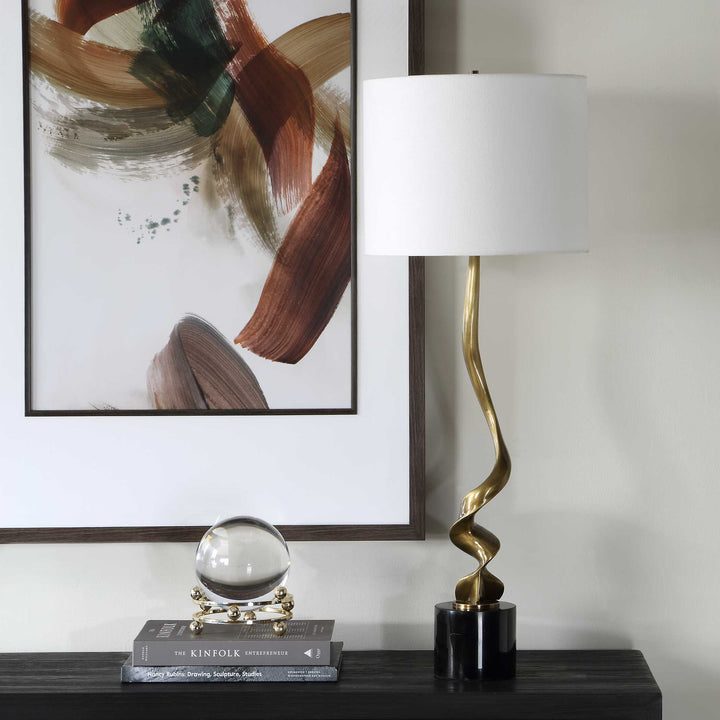 Decorative lamp with a white shade and gold base