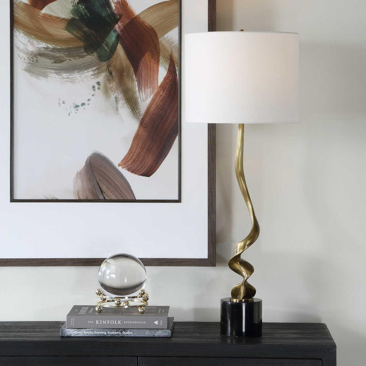 table lamp with a gold spiral base and white shade