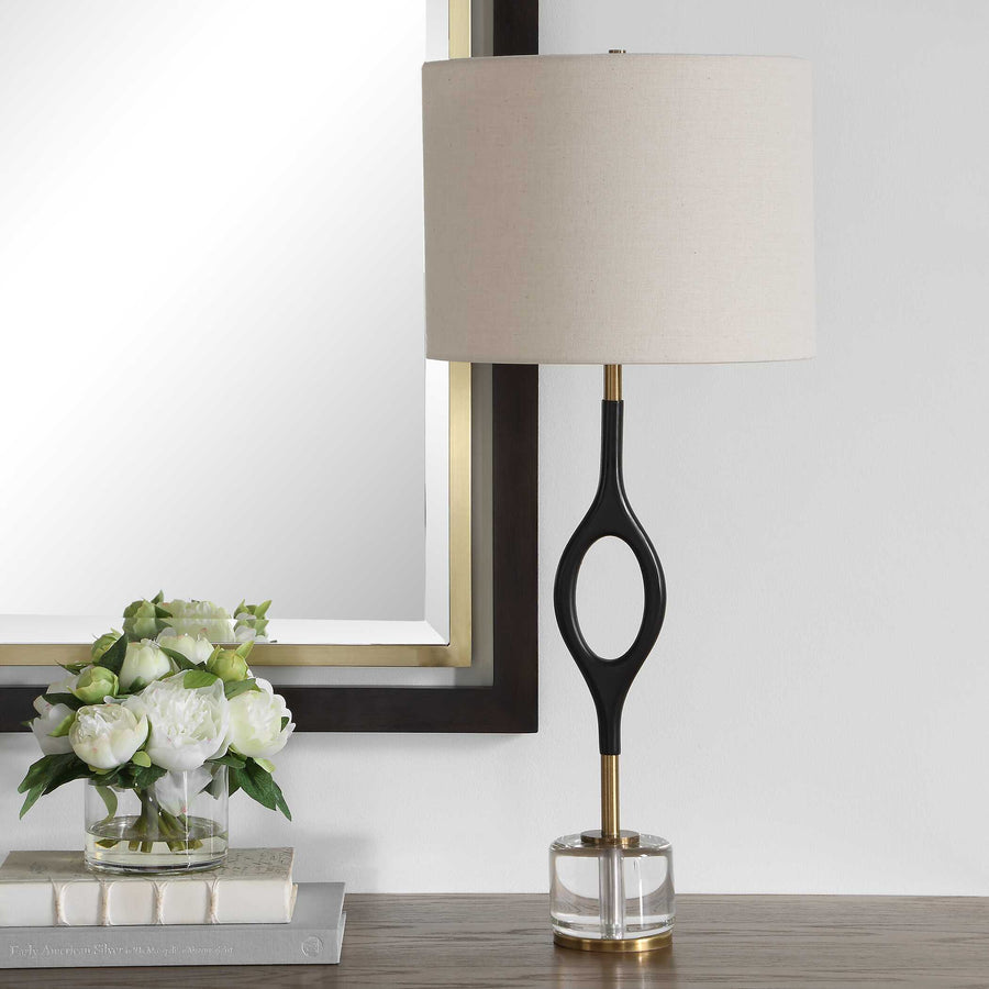 Table lamp with a black and gold base and white shade