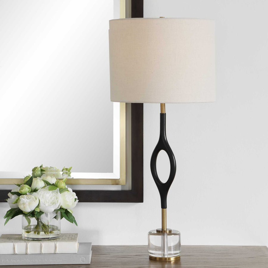 Table lamp with a black and gold base and white shade