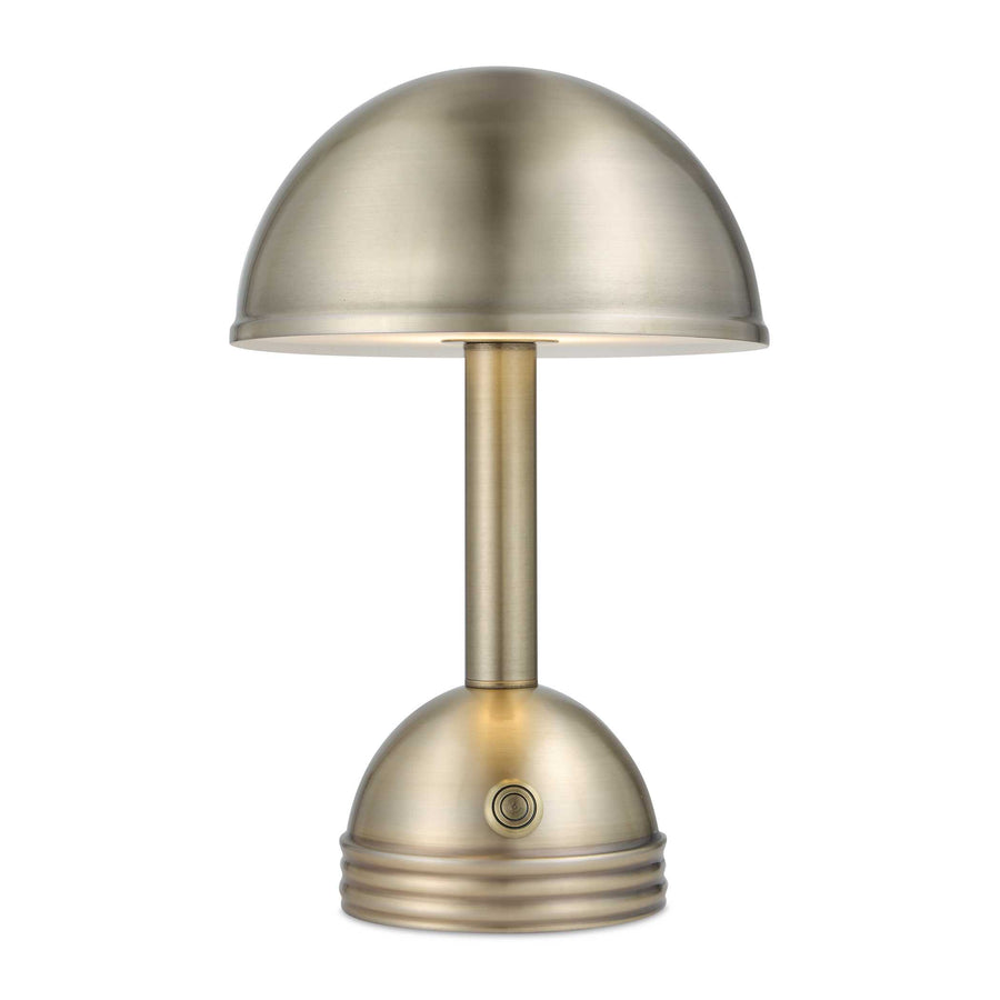 A modern table lamp with a dome-shaped shade and matching base in a brushed brass or antique gold finish