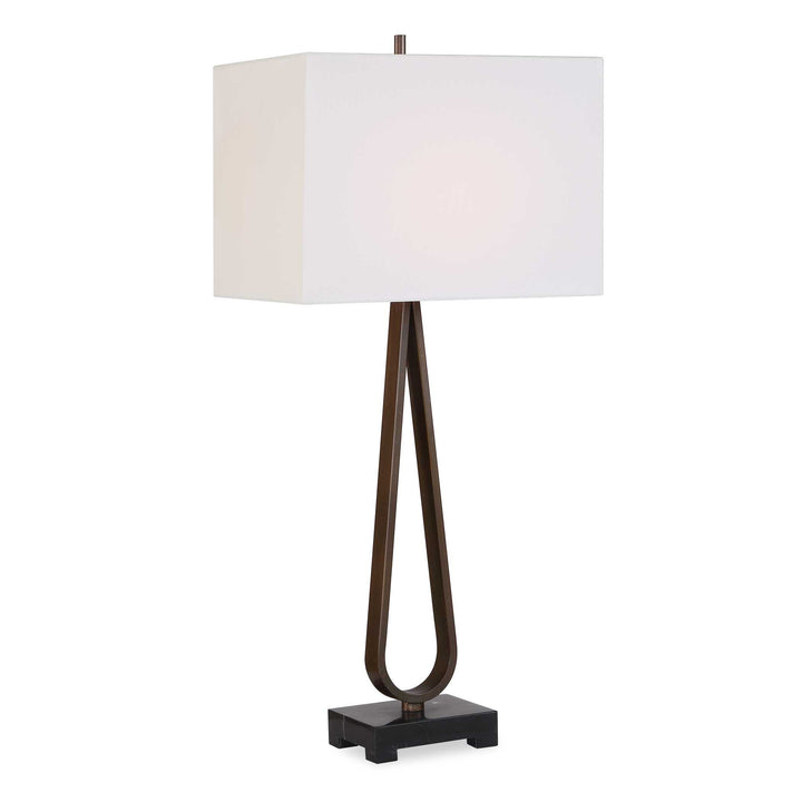Table lamp with a white shade and bronze base and black marble foot