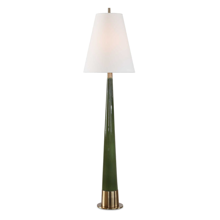 mid-century modern style table lamp with a tall, slender tapered ceramic body in a glossy moss green finish. The lamp features a brushed gold metallic base and matching neck hardware, topped with a crisp white tapered fabric drum shade