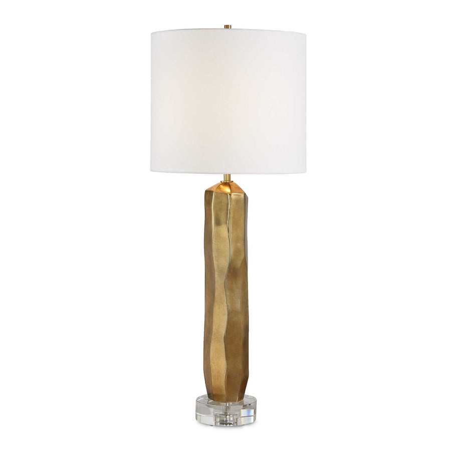 Table lamp with gold base and white shade on a white background