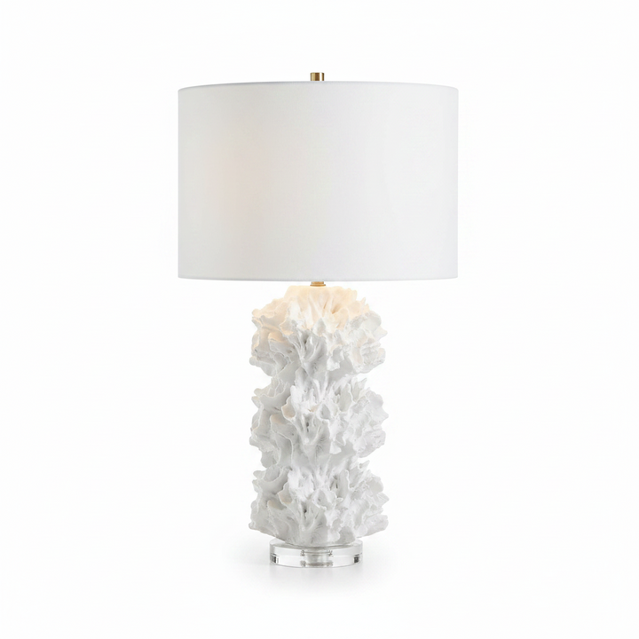 Table lamp with white coral base and white shade on a plain background