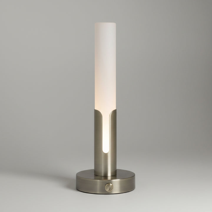 A modern table lamp with a frosted white cylindrical shade and a brushed brass-finish base