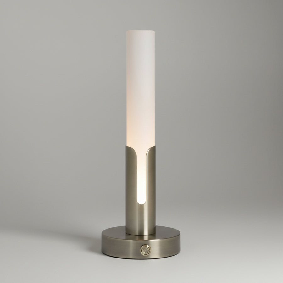 A modern table lamp with a frosted white cylindrical shade and a brushed brass-finish base