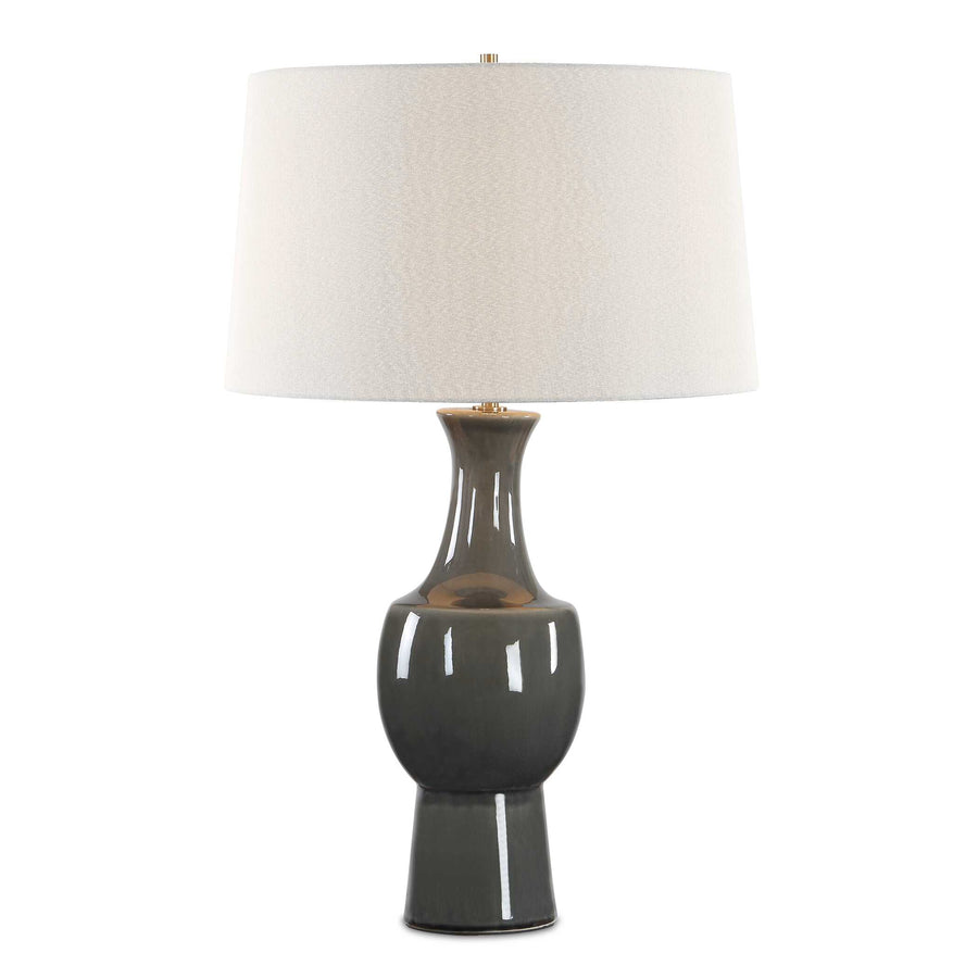 A table lamp with a glossy dark gray ceramic base and a textured off-white fabric drum shade
