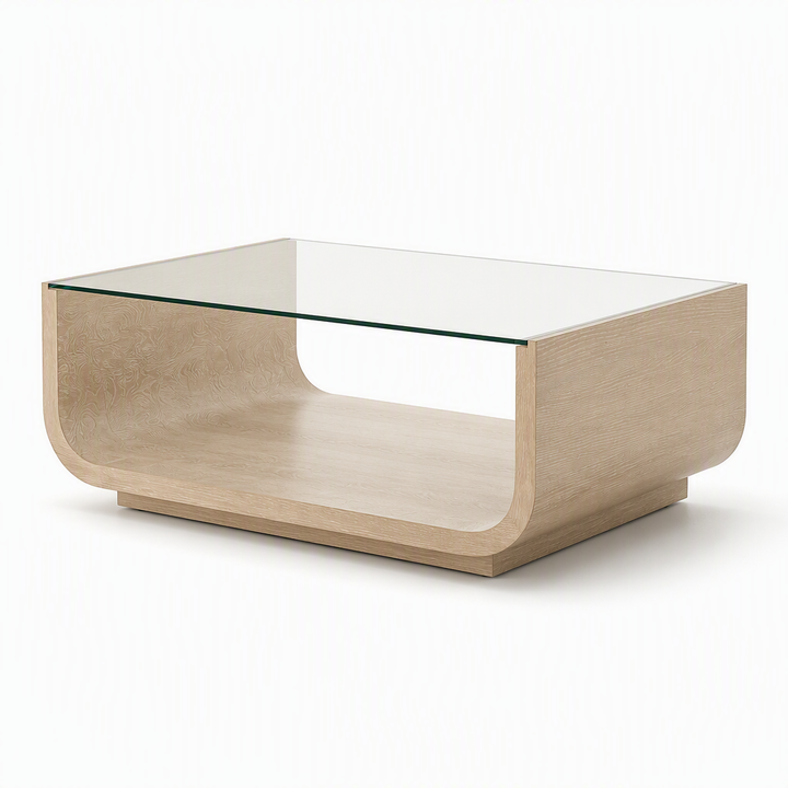 A modern rectangular coffee table with a light beige wood grain finish, featuring a clear glass top and an open lower shelf, set against a plain white background.