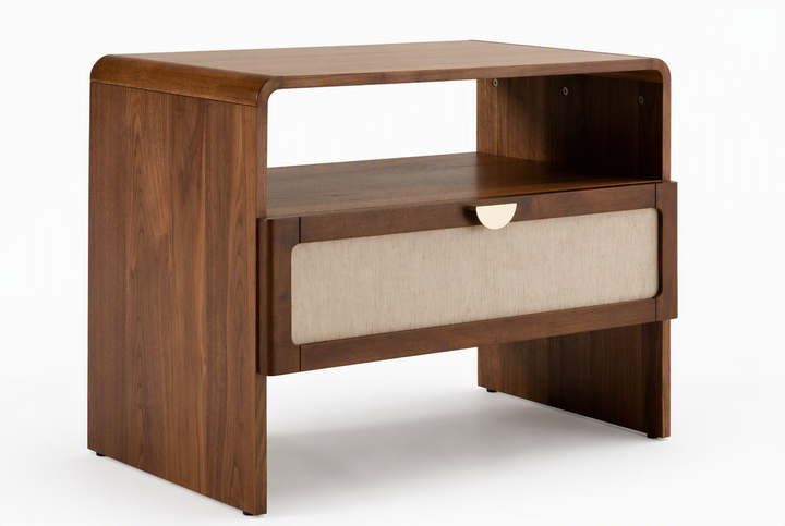 wooden nightstand with a walnut finish, featuring a single drawer with a beige fabric insert and a small brass pull handle.