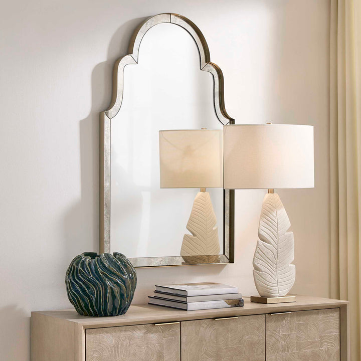 Decorative mirror on a beige wall