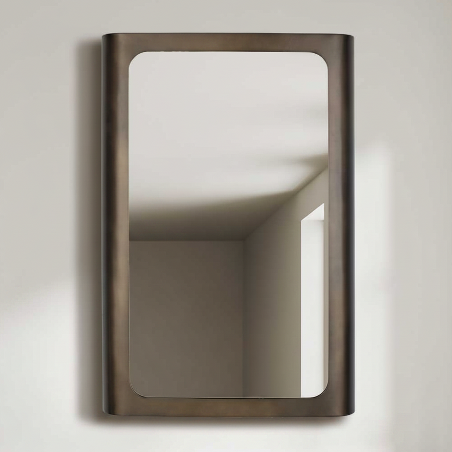 Rectangular mirror with bronze frame isolated on a light gray wall