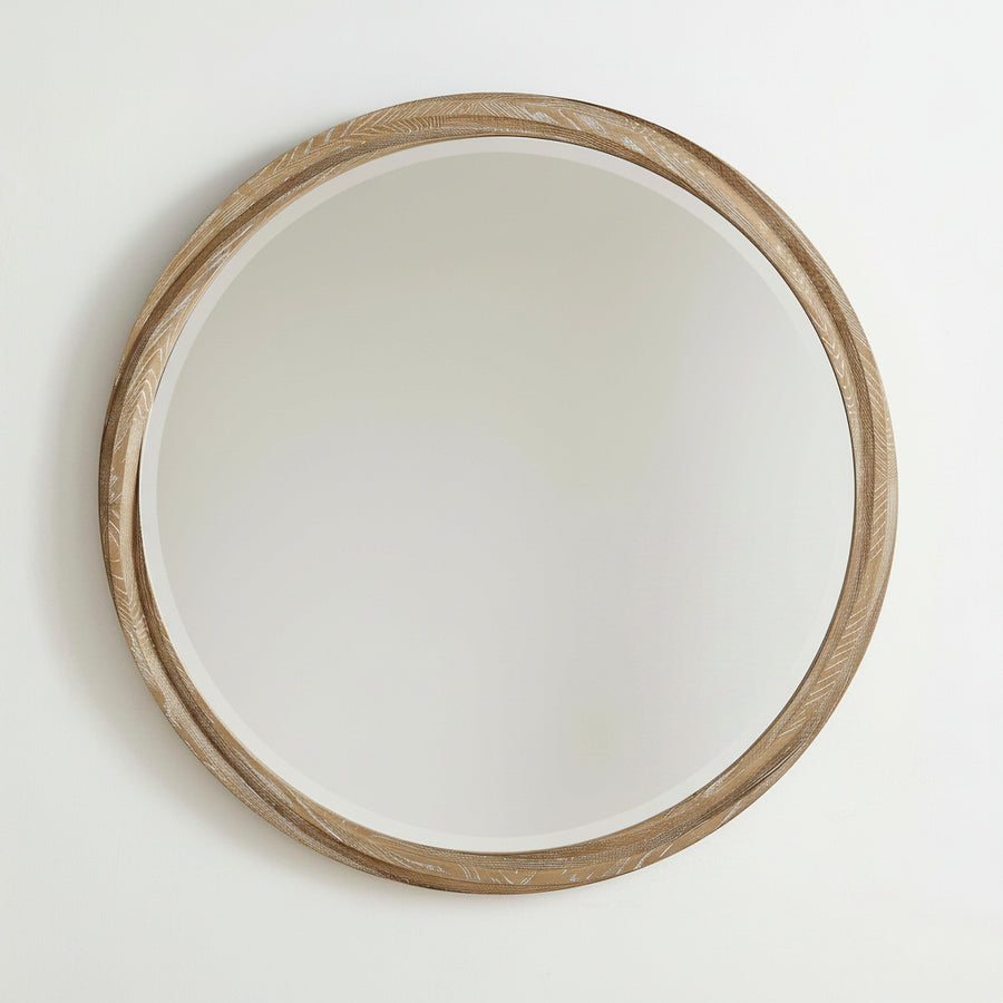 Round wooden-framed mirror isolated on a wall