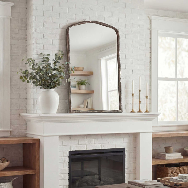 White brick fireplace with a mirror above it, wooden shelves, and decorative items.