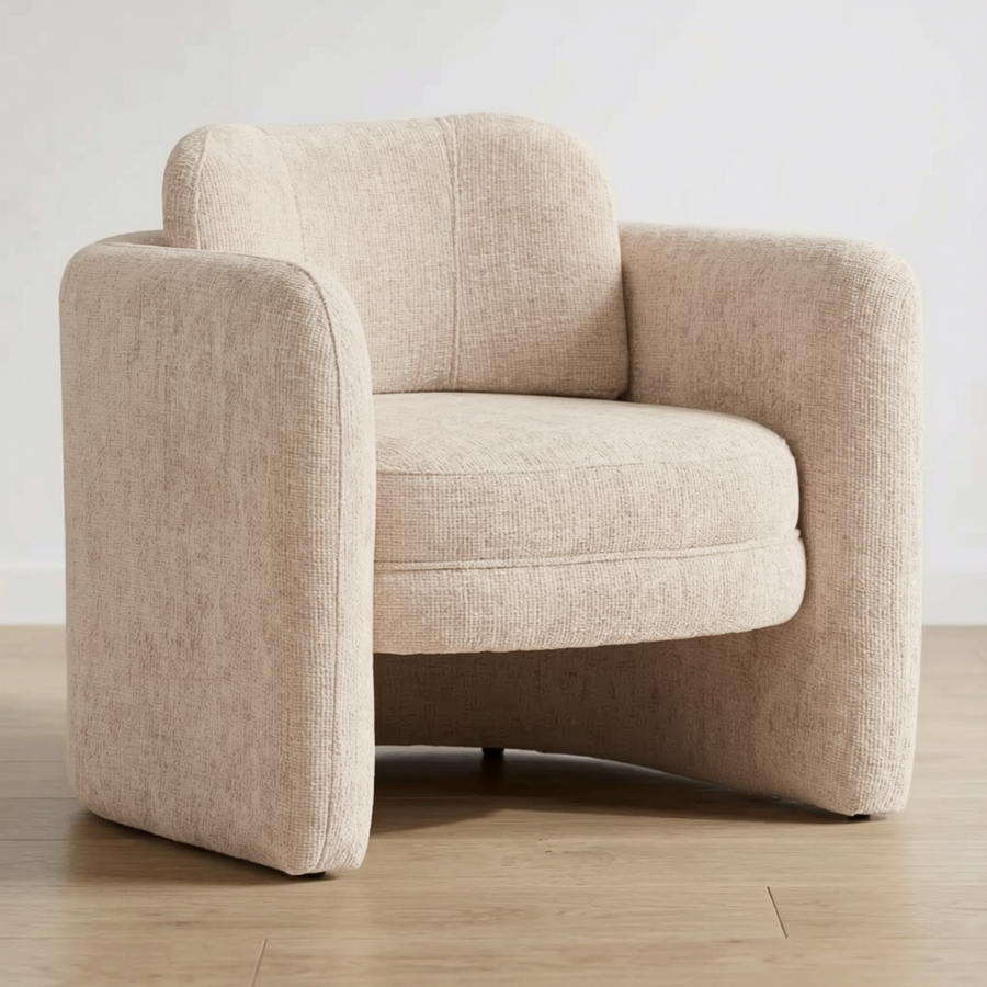 Beige armchair on a wooden floor with a white background