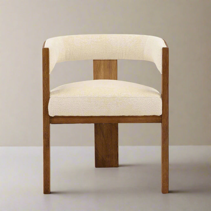 Chair with wooden frame and beige cushion on a white background