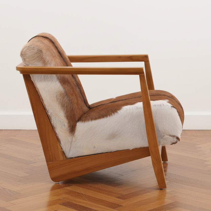Wooden armchair with brown and white fur upholstery on a white background