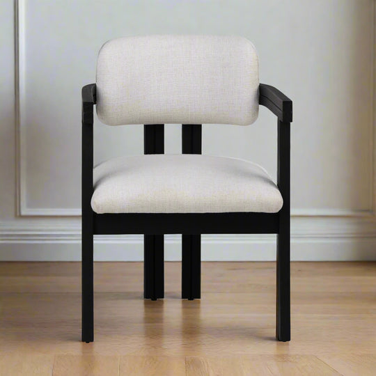 Chair with black frame and white cushion on a white background