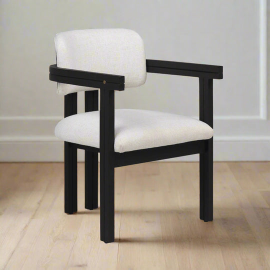 Chair with black frame and white cushion on a white background