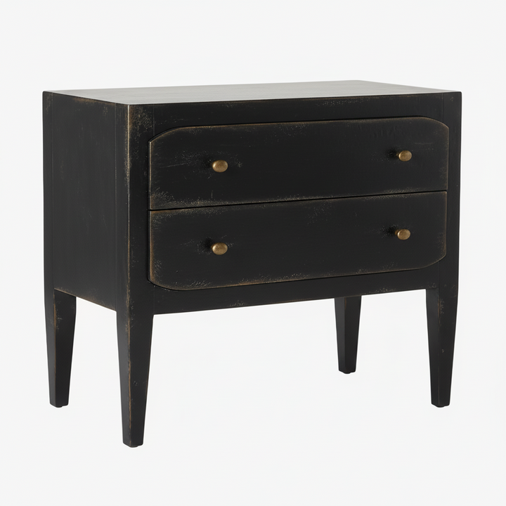 A distressed black two-drawer nightstand with brass knobs, photographed against a neutral light gray background.