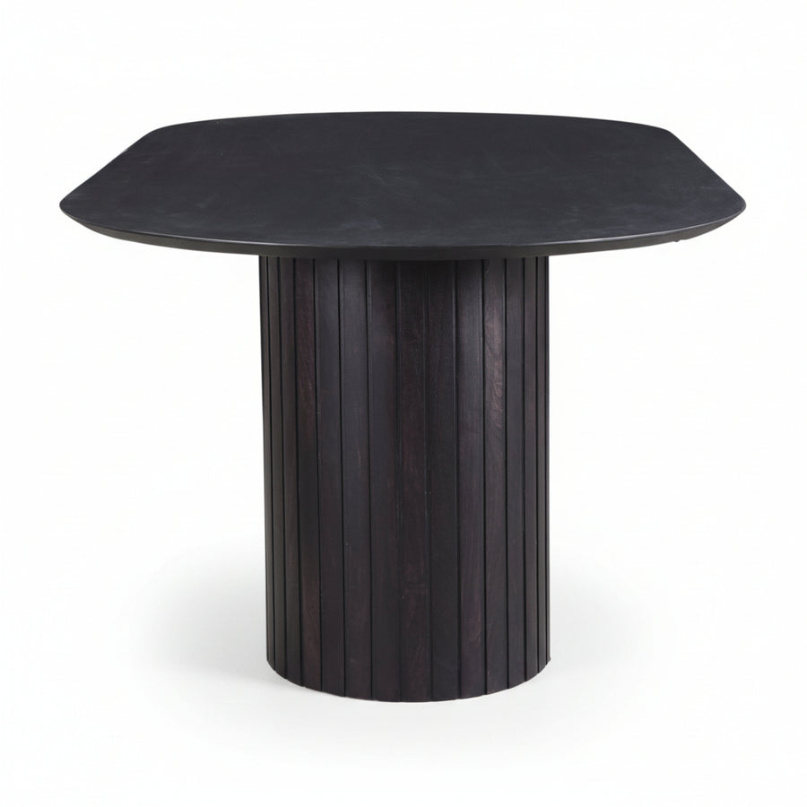 modern black wooden oval table with ribbed cylindrical legs on a white background