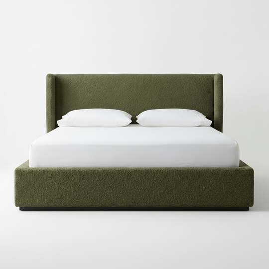 Green upholstered bed with white bedding on a plain background