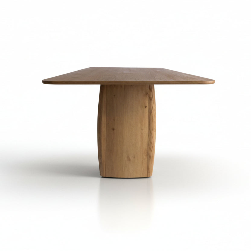 Wooden dining table with a unique base design on a white background