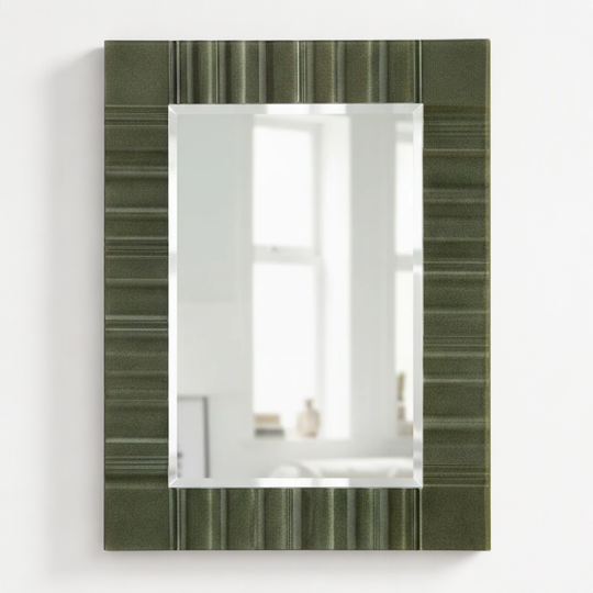 A rectangular wall mirror with a textured olive green frame featuring horizontal striped patterns, shown against a plain white background.