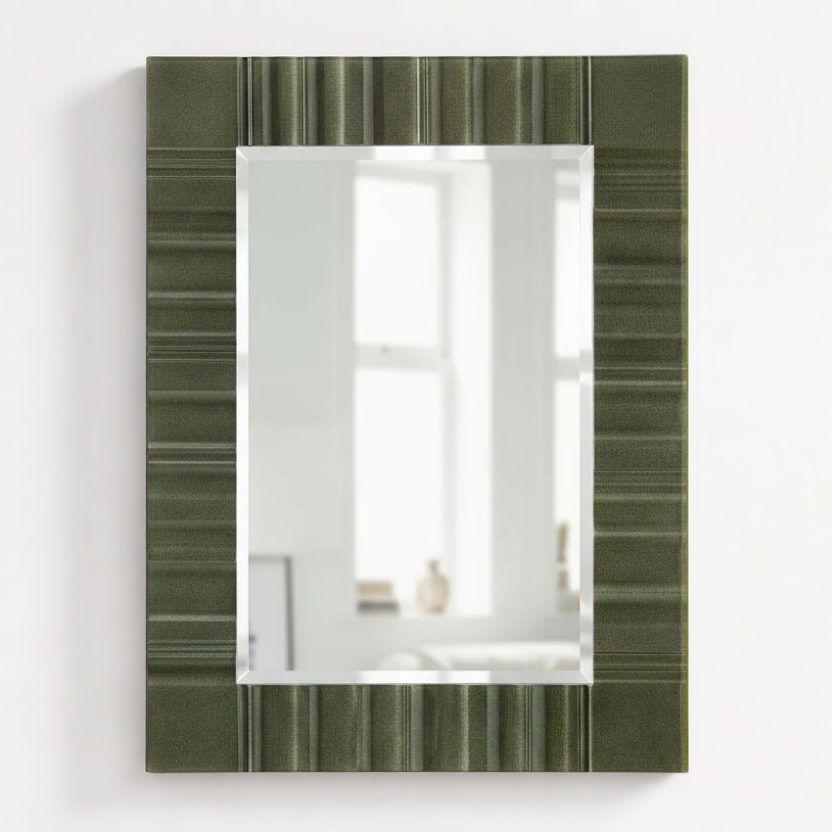 A rectangular wall mirror with a textured olive green frame featuring horizontal striped patterns, shown against a plain white background.
