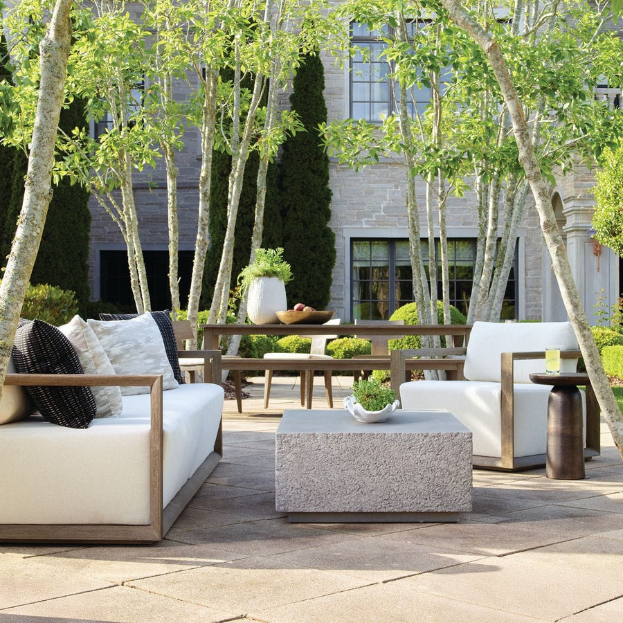 Outdoor patio with modern furniture and trees in an urban setting