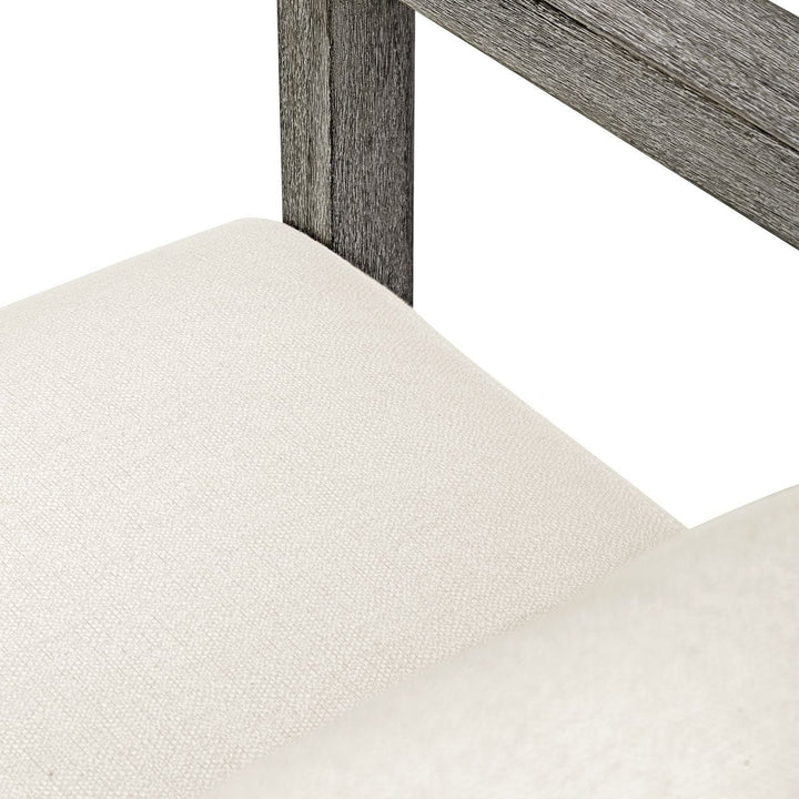 Close-up of a chair with a wooden frame and white cushioned seat on a white background