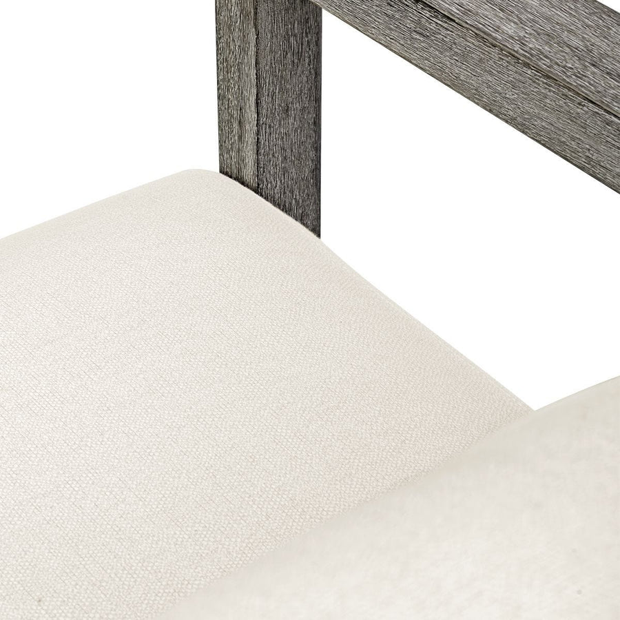 Close-up of a chair with a wooden frame and white cushioned seat on a white background