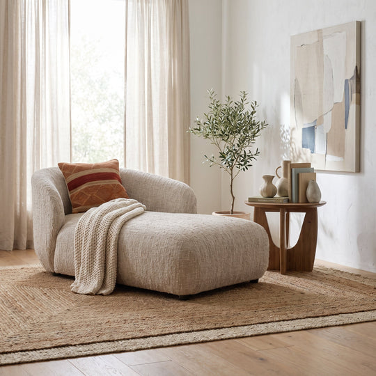 Rhoda Chaise in Napa Beige Boucle styled in a bright, modern living room with a textured rug, side table, and decor.