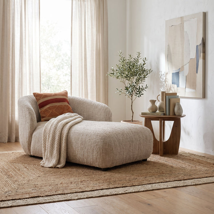 Rhoda Chaise in Napa Beige Boucle styled in a bright, modern living room with a textured rug, side table, and decor.