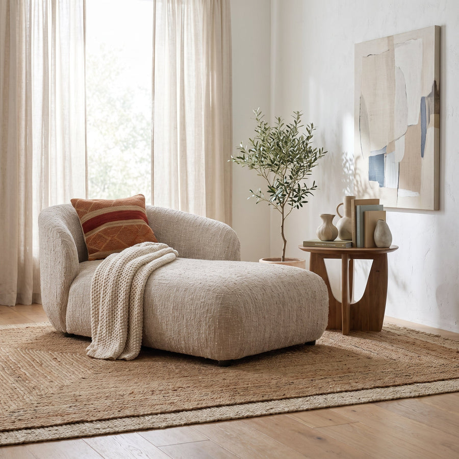 Rhoda Chaise in Napa Beige Boucle styled in a bright, modern living room with a textured rug, side table, and decor.