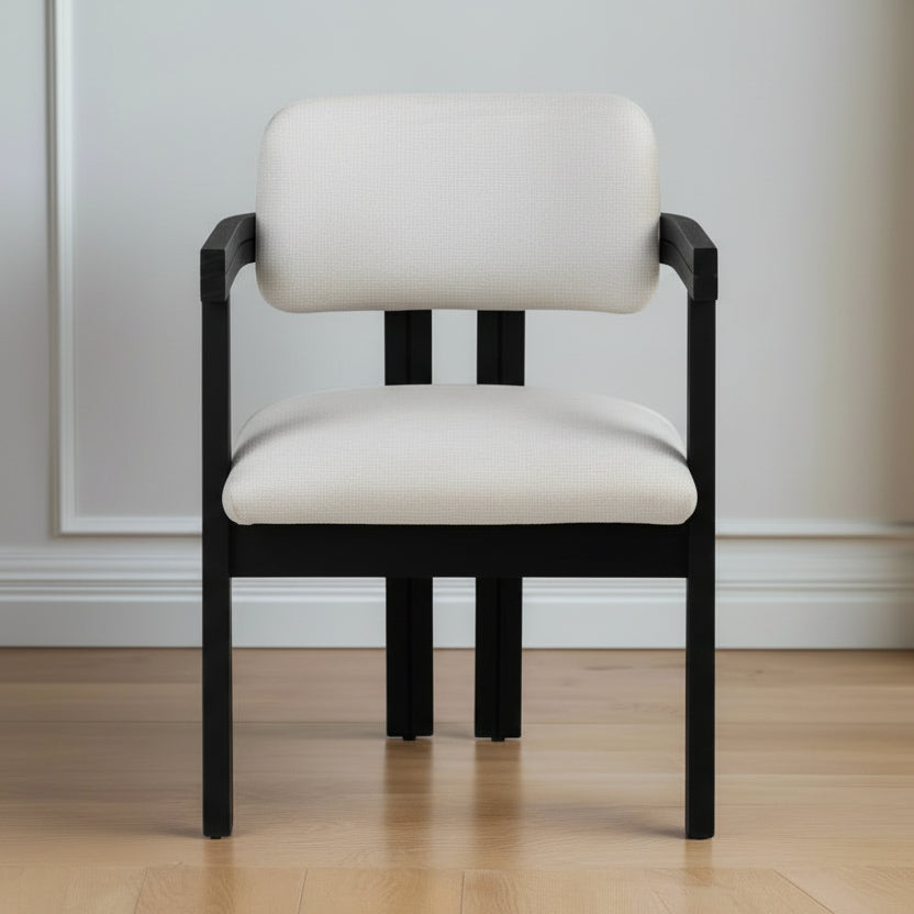 Chair with black frame and light beige cushions on a wooden floor