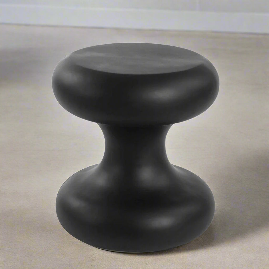 Black cylindrical object on a white background