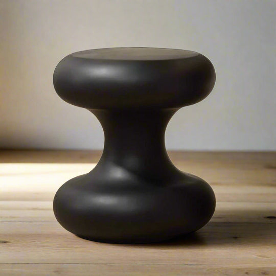 Black modern stool on a light wooden floor