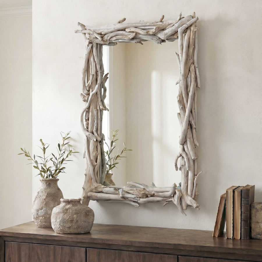 Driftwood-framed mirror isolated on a white wall