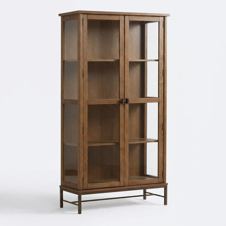 Wooden display cabinet with glass doors on a plain background