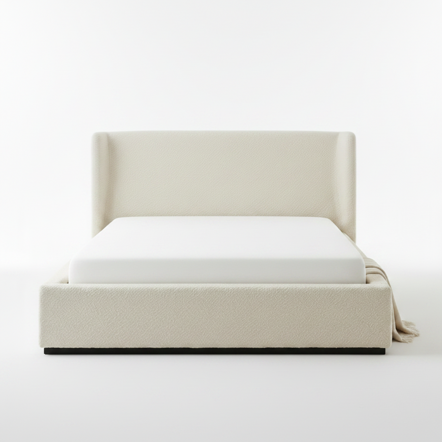 Beige upholstered bed with white mattress on a plain background