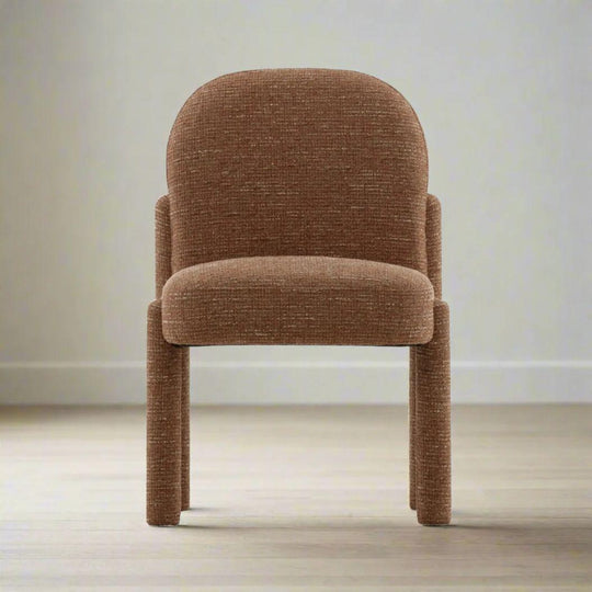 Brown upholstered chair on a light wooden floor with a neutral wall background