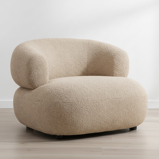 Beige armchair on a wooden floor with a white background