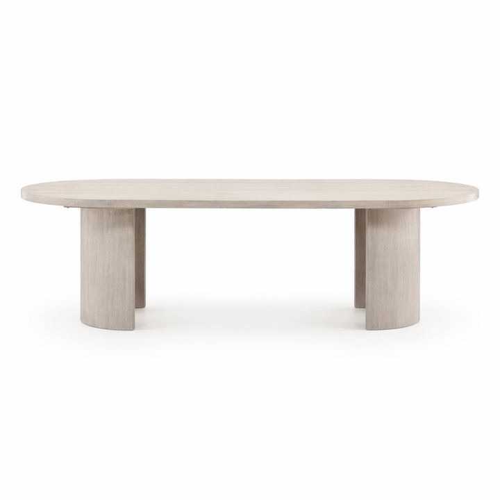A modern oval dining table with a light gray wood grain finish and thick cylindrical legs, shown against a plain white background.